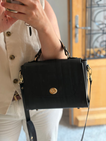 le sac est présenté porté au creux du coude par le mannequin. 